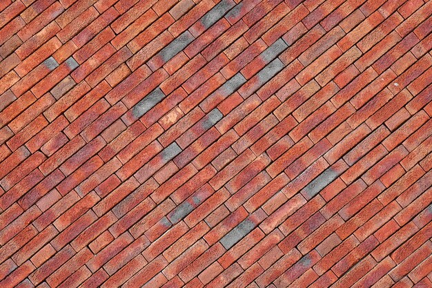 Red brick wall background Photo of a sloping red brick wall