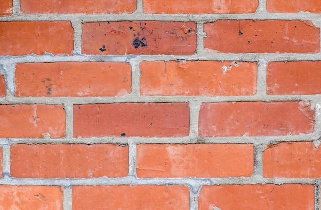 Red brick wall surface with visible cement joint for background