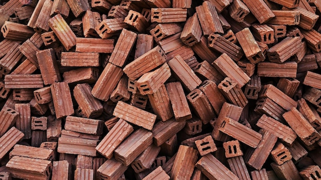 Red bricks are piled in large numbers to prepare for the construction of various buildings Stack of red clay bricks for construction site