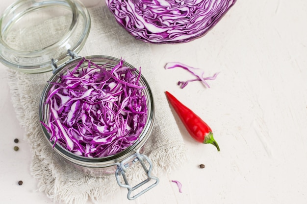 Red cabbage is chopped in a jar. Preparation for fermentation. 