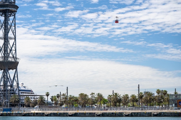 Red cable car and tower at Barcelona Port Vell Funicular to the Montjuic in Barcelona