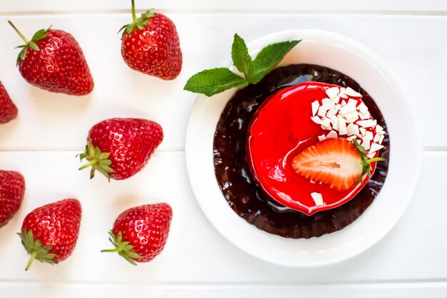 Red cake with fresh strawberries and mint leaves