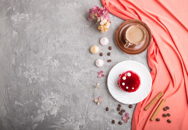 Red cake with souffle cream with cup of coffee. top view, copyspace.