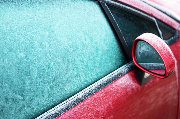 Red car on the street with frozen windows