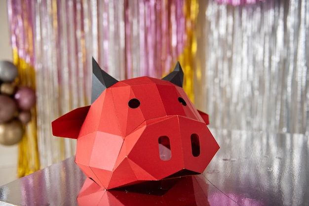 Red cardboard bull mask lies on a silver floor