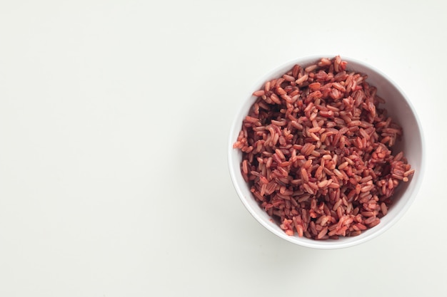 Red Cargo Rice garnished in white bowl on white desk