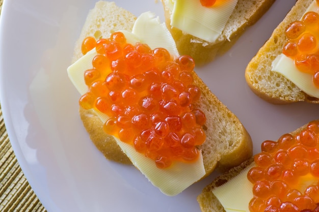 Red caviar on bread with butter closeup lots of sandwiches