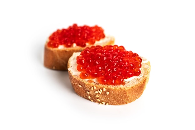 Red caviar isolated on a white background Sandwiches with red caviar High quality photo