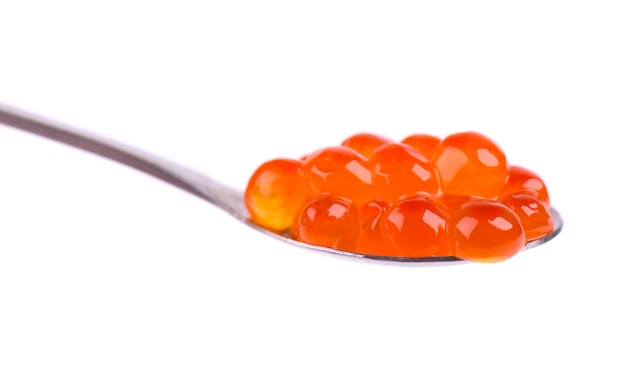 Red caviar in spoon isolated  with clipping path. Close up. Macro.