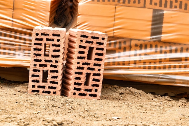 Red ceramic bricks at the construction site Keramoblock Hollow brick Construction of a red brick building Closeup Material for the construction of walls and partitions