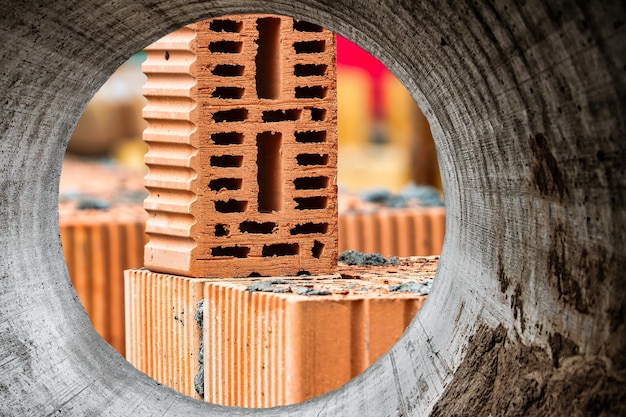 Red ceramic bricks at the construction site Keramoblock Hollow brick Construction of a red brick building Closeup Material for the construction of walls and partitions