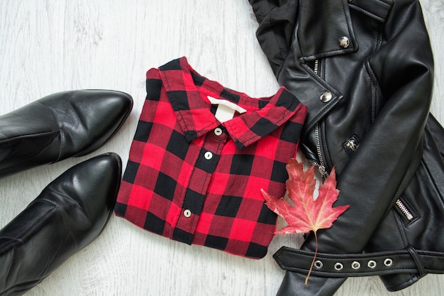 Red checkered shirt, black jacket and maple leaf. Fashionable concept