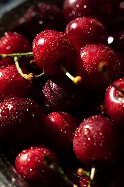 Red cherries in drops of water in a bowl