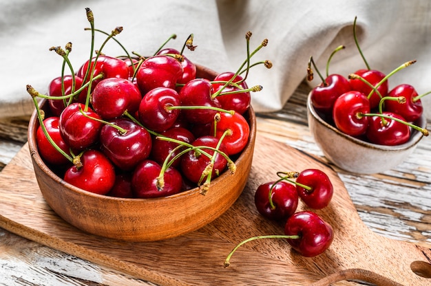 Red cherries in a wooden bowl