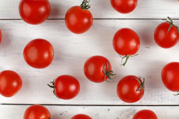 Red cherry tomato on a white table Background or texture with tomatoes