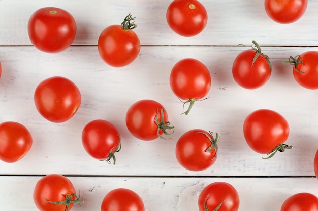 Red cherry tomato on a white table Background or texture with tomatoes