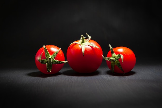 Red cherry tomatoes isolated on black