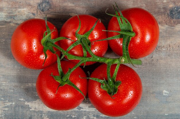 Red cherry tomatoes on the rustic background