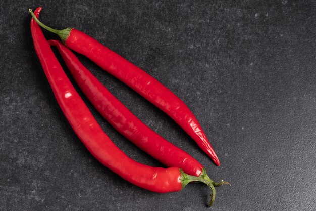 Red chili peppers on a granite gray table