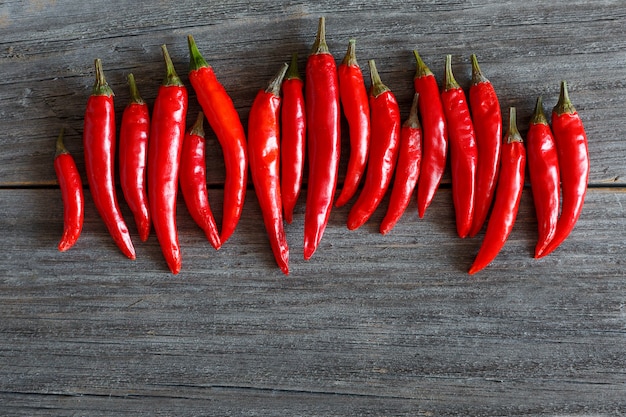 Red chili peppers on wooden board