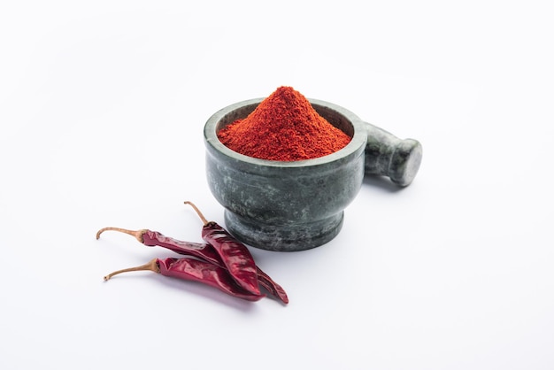 Red Chilli or Lal Mirchi or mirch with Powder in a bowl or mortar over moody background, selective focus