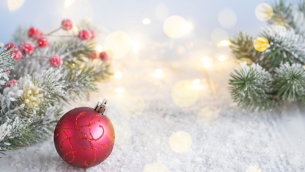 Red Christmas ball on the background of fir branches