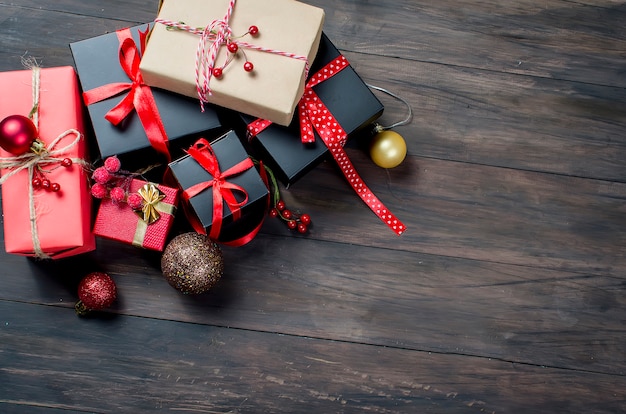 Red christmas  gift  box with red ribbon and fir branches