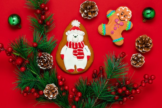 Red Christmas orthodox card is decorated with gingerbread cookies in the shape of a stylized polar bear.