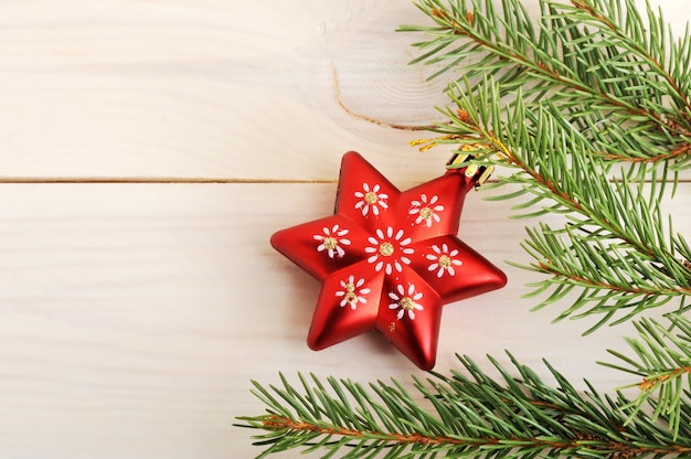 Red Christmas tree toy in the form of stars on a fir branch 