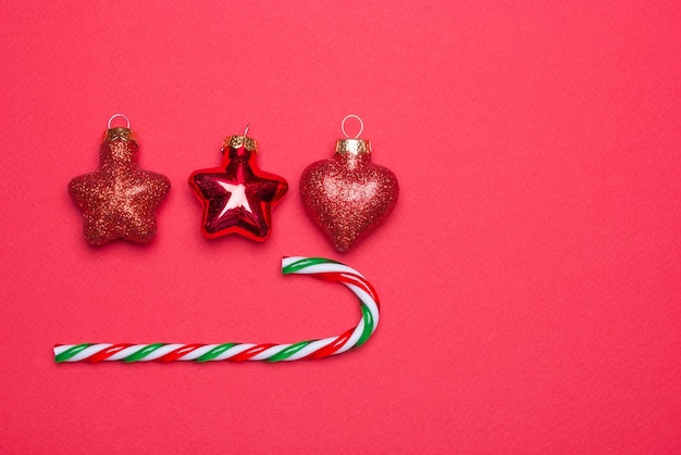 Red Christmas tree toys lined up against a red background