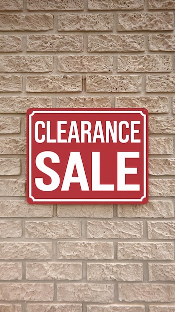 Photo red clearance sale sign stands out on textured brick wall vertical mobile wallpaper