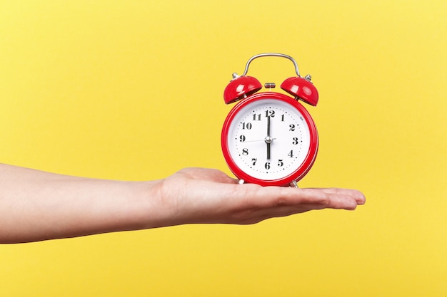 Red clock with alarm on hand