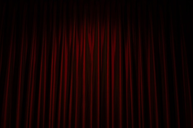 Red closed curtain with light in a theater. Curtains with spotlight in the cinema.