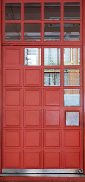 Red closed wood door with glass window