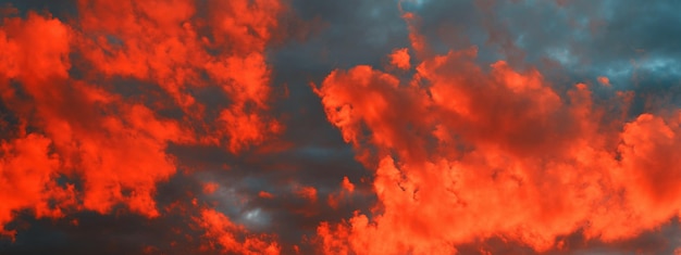 Red cloudy sunset on blue sky in evening Nature banner