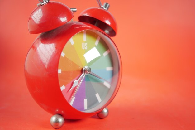 Red color old alarm clock red background