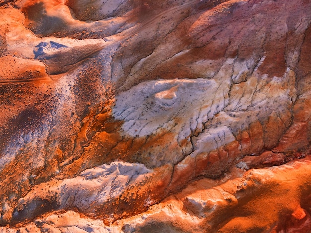 Red colorful mountains abstract nature background Aerial top down view Altai Siberia Russia