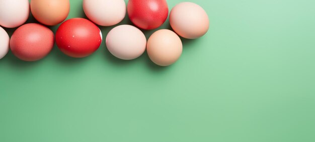 Red and creamcolored eggs presented on a fresh green surface create a vibrant contrast Perfect for springthemed designs and Easter event advertisements Banner with copy space Top view