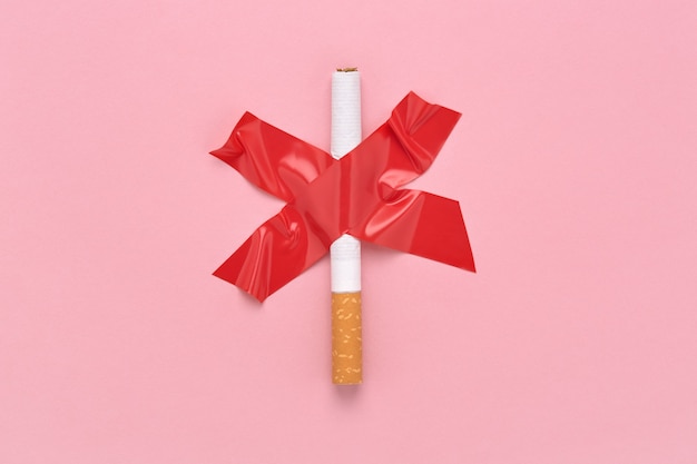 Red cross sign glued a cigarette, No smoking symbol.