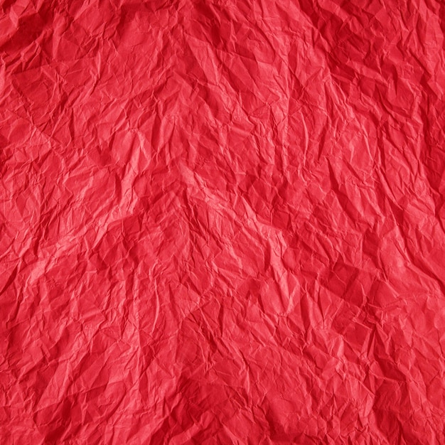 Red crumpled paper close up texture background