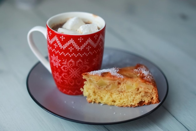 Red Cup with hot drink and marshmallow inside.