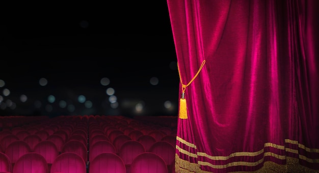 The red curtains of the stage are opening for the theater show