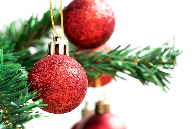 Red decoration ball on green christmas tree 