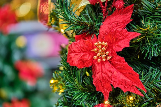 Red decoration in the form of a flower on a Christmas tree