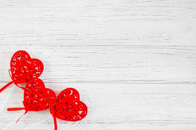 Red decorative hearts on a white background from boards