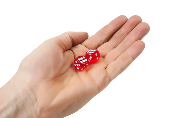 Red dice in the hand on a white background