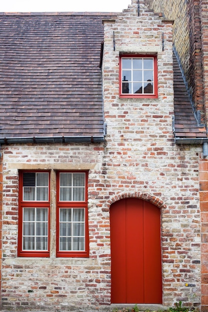 Red door on old European stone house of Bruges, Belgium