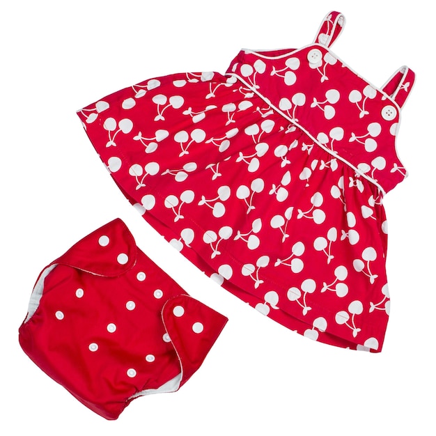 Red dress and reusable diaper for little girl on white isolated background