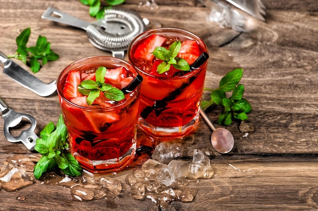 Red drink cocktail with ice mint leaves strawberry