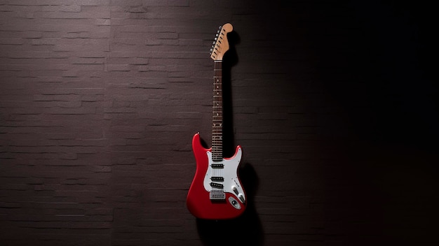 A red electric guitar with the word strat on the front.